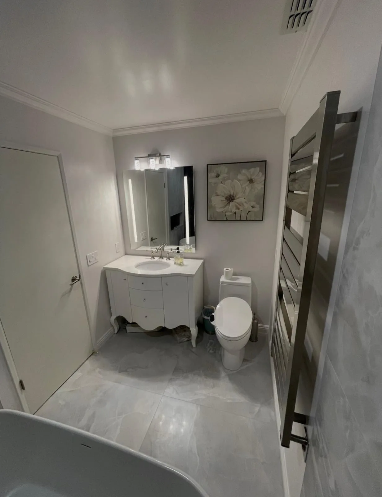 New bathroom vanity with lighted mirror and heated towel rack